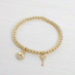 Pulsera Elástica de Bolitas en Baño de Oro con Dijes de Candado de Corazón y Llave