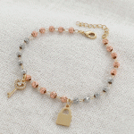 Pulsera Esferas Facetadas en Tres Oros con Dijes de Llave y Candado